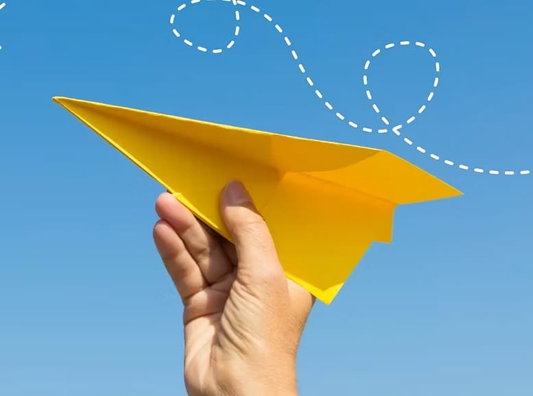 hand holding paper plane line white dotted lines
